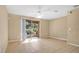 Spacious living room with tile floors and sliding glass doors to a patio at 1336 Chelsea Dr, Davenport, FL 33897
