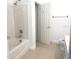 Bathroom with tub, toilet and a door to another room at 2857 Lyndscape St, Orlando, FL 32833