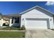 Newly constructed one-story home with a two-car garage and a well-maintained lawn at 2857 Lyndscape St, Orlando, FL 32833