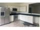 Modern kitchen with white cabinets and black countertops at 2857 Lyndscape St, Orlando, FL 32833