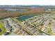 Aerial view of community, highlighting its lakeside location and homes at 3571 Maple Ridge Loop, Kissimmee, FL 34741