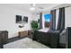Cozy bedroom with dark grey bedding and large window at 3571 Maple Ridge Loop, Kissimmee, FL 34741