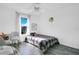 Bright bedroom with a plaid comforter and window at 3571 Maple Ridge Loop, Kissimmee, FL 34741