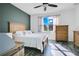 Bright bedroom with wood floors, a wooden dresser, and a large window at 3571 Maple Ridge Loop, Kissimmee, FL 34741