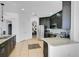 Modern kitchen with dark cabinets, granite countertops, and stainless steel appliances at 3571 Maple Ridge Loop, Kissimmee, FL 34741