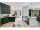 Modern kitchen with dark cabinets, granite countertops, and stainless steel appliances at 3571 Maple Ridge Loop, Kissimmee, FL 34741