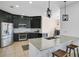 Modern kitchen with dark cabinets, granite countertops, and stainless steel appliances at 3571 Maple Ridge Loop, Kissimmee, FL 34741