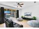 Living room with sliding doors leading to a pool and patio, featuring two beanbag chairs and a leather sofa at 3571 Maple Ridge Loop, Kissimmee, FL 34741