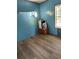 Bedroom with blue walls and wood-look flooring at 4914 Dove Ln, Auburndale, FL 33823