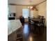 Kitchen and dining area with wood-look flooring and a wood dining table at 4914 Dove Ln, Auburndale, FL 33823