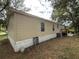 Side view of mobile home showing exterior condition at 4914 Dove Ln, Auburndale, FL 33823