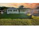 Charming bungalow with a newly renovated exterior, featuring a landscaped lawn and driveway at 527 Sunrise Dr, Orlando, FL 32803