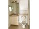 Simple bathroom with vanity, toilet, and a medicine cabinet at 8910 Legacy Ct # 206, Kissimmee, FL 34747
