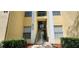 Condo building entrance with stairs and landscaping at 8910 Legacy Ct # 206, Kissimmee, FL 34747