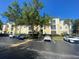 Condo building exterior with parking lot and landscaping at 8910 Legacy Ct # 206, Kissimmee, FL 34747