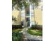 Exterior view of condo building showcasing stairs and landscaping at 8910 Legacy Ct # 206, Kissimmee, FL 34747