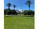 Front view of Legacy Dunes community entrance with lush landscaping and flagpoles at 8910 Legacy Ct # 206, Kissimmee, FL 34747