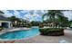 Resort-style pool with lounge chairs and umbrellas at 8910 Legacy Ct # 206, Kissimmee, FL 34747