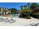 Community pool with lounge chairs and a surrounding patio at 8910 Legacy Ct # 206, Kissimmee, FL 34747