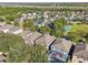Aerial view of community, highlighting homes, landscaping, and a pool and basketball court at 9026 Dry Creek Ln, Orlando, FL 32832