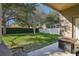 Spacious backyard with grassy area, fire pit, and covered patio at 9026 Dry Creek Ln, Orlando, FL 32832