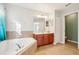 Primary bathroom with corner soaking tub and double vanity at 9026 Dry Creek Ln, Orlando, FL 32832