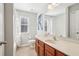 Simple bathroom with a tub shower combo, wood vanity, and updated fixtures at 9026 Dry Creek Ln, Orlando, FL 32832