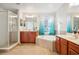 Elegant Primary bathroom with double sinks, soaking tub, and walk-in shower at 9026 Dry Creek Ln, Orlando, FL 32832