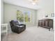 Bright bedroom featuring a large window and comfortable recliner at 9026 Dry Creek Ln, Orlando, FL 32832