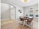 Elegant dining room with hardwood floors, a round table, and access to the foyer at 9026 Dry Creek Ln, Orlando, FL 32832