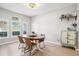 Dining room features hardwood floors, a round wooden table, and large windows at 9026 Dry Creek Ln, Orlando, FL 32832