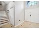 Bright entryway with tiled floors, staircase, and coat rack at 9026 Dry Creek Ln, Orlando, FL 32832