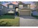 Two-story house with a large front yard and attached garage at dusk at 9026 Dry Creek Ln, Orlando, FL 32832