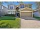 Two-story house with a large front yard, driveway, and attached garage at 9026 Dry Creek Ln, Orlando, FL 32832