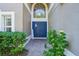 Inviting front entrance with double blue doors and landscaping at 9026 Dry Creek Ln, Orlando, FL 32832