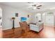 Spacious living room with hardwood floors, comfortable seating, and large TV at 9026 Dry Creek Ln, Orlando, FL 32832