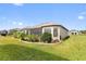 Well-maintained backyard with lush landscaping and screened-in porch at 972 Ladera Ranch Rd, Kissimmee, FL 34759
