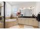 Bright bathroom with double vanity, soaking tub, and walk-in shower at 972 Ladera Ranch Rd, Kissimmee, FL 34759