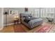 Spacious bedroom with plush bed, wood floors, and ample natural light at 972 Ladera Ranch Rd, Kissimmee, FL 34759