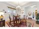Bright dining room with a glass-top table and chandelier at 972 Ladera Ranch Rd, Kissimmee, FL 34759