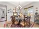 Elegant dining room featuring a glass-top table and chandelier at 972 Ladera Ranch Rd, Kissimmee, FL 34759
