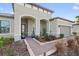 Front entrance with brick walkway, landscaping, and arched entryway at 972 Ladera Ranch Rd, Kissimmee, FL 34759