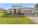 One-story home with a two-car garage and well-manicured lawn at 972 Ladera Ranch Rd, Kissimmee, FL 34759