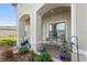 Inviting front porch with seating area and potted plants at 972 Ladera Ranch Rd, Kissimmee, FL 34759