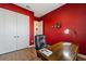 Bright home office with a large desk and red walls at 972 Ladera Ranch Rd, Kissimmee, FL 34759