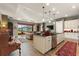 Open concept kitchen with island, stainless steel appliances, and hardwood floors at 972 Ladera Ranch Rd, Kissimmee, FL 34759