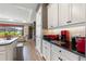 Kitchen features granite countertops, white cabinetry, and breakfast bar at 972 Ladera Ranch Rd, Kissimmee, FL 34759