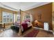 Main bedroom with a four-poster bed and window seating at 972 Ladera Ranch Rd, Kissimmee, FL 34759