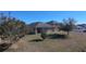 Spacious backyard with mature trees and open grassy area at 102 Lake Tracy Ct, Haines City, FL 33844