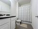 Clean bathroom with shower/tub combo, vanity, and dark-colored countertop at 102 Lake Tracy Ct, Haines City, FL 33844